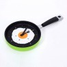 Metal wall clock in the shape of a frying pan with a fried eggClocks